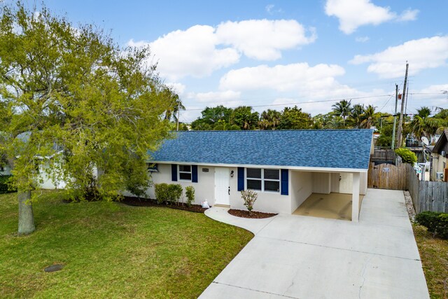 ranch-style house with driveway, a shingled roof, a front lawn, and stucco siding