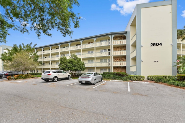 view of property featuring uncovered parking