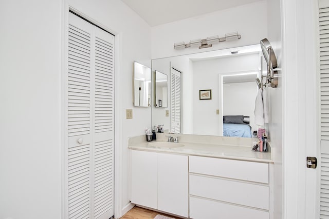 bathroom featuring vanity and a closet