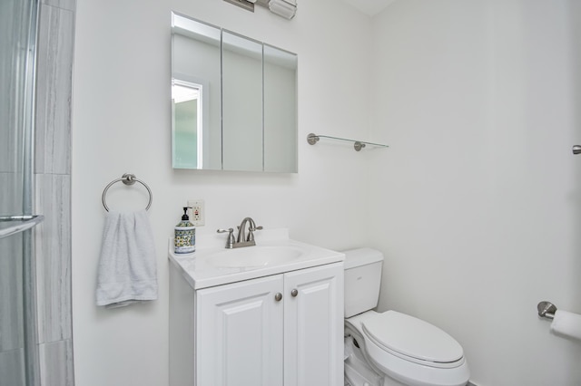 full bathroom with a shower with shower door, toilet, and vanity