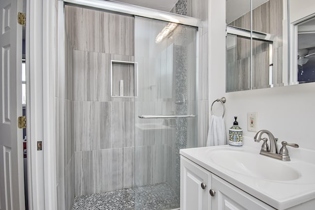 bathroom with a stall shower and vanity