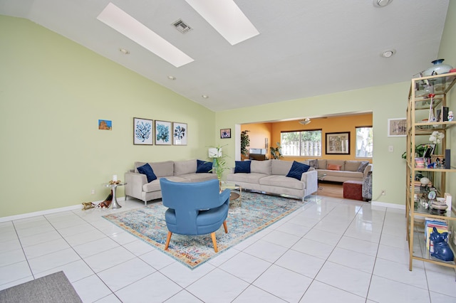 living room featuring light tile patterned floors, visible vents, lofted ceiling with skylight, and baseboards