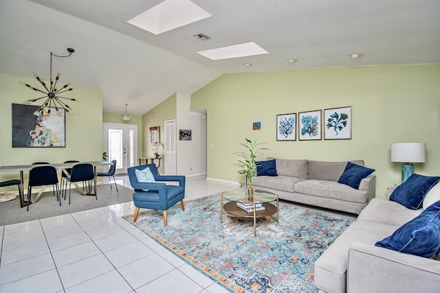 tiled living area with visible vents, vaulted ceiling with skylight, and baseboards