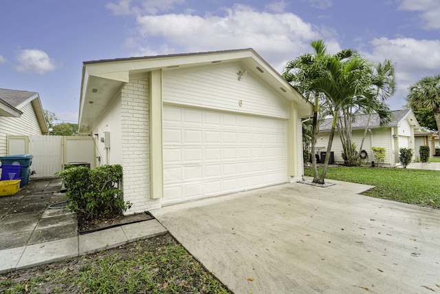 garage with driveway and a gate