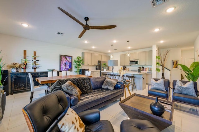 living area with light tile patterned floors, visible vents, and recessed lighting