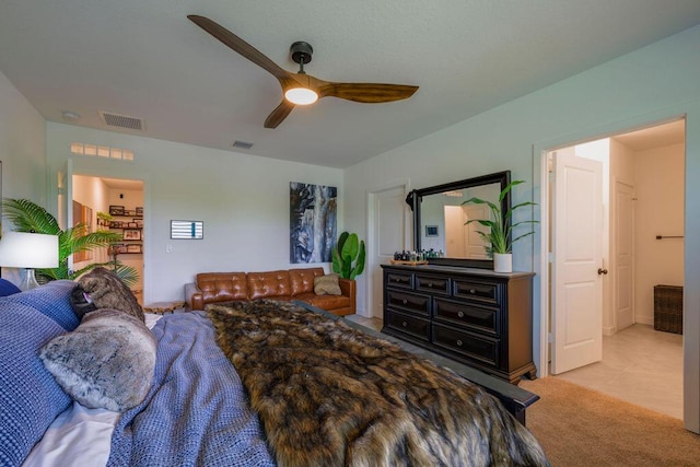 bedroom featuring light colored carpet, visible vents, and ceiling fan