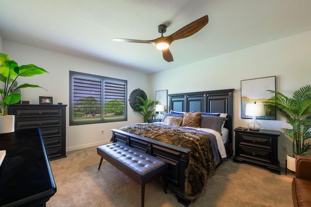 carpeted bedroom featuring a ceiling fan and baseboards