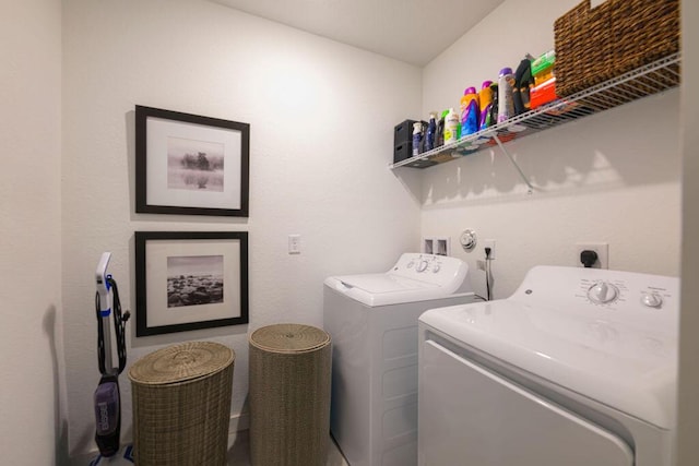 washroom with laundry area and washer and dryer