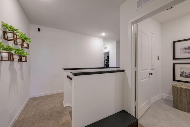 interior space with light colored carpet, visible vents, and baseboards