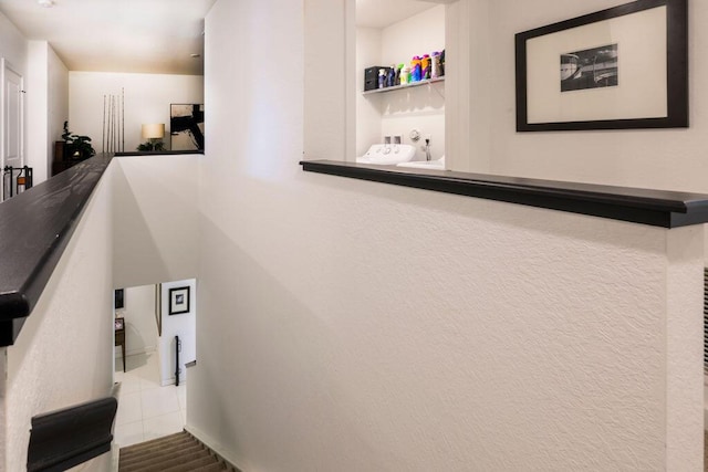 stairway featuring tile patterned flooring