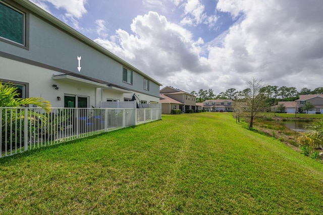 view of yard featuring fence and a residential view