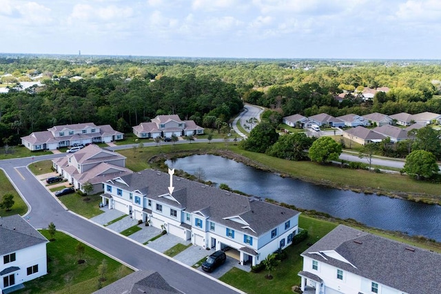 birds eye view of property with a forest view, a water view, and a residential view