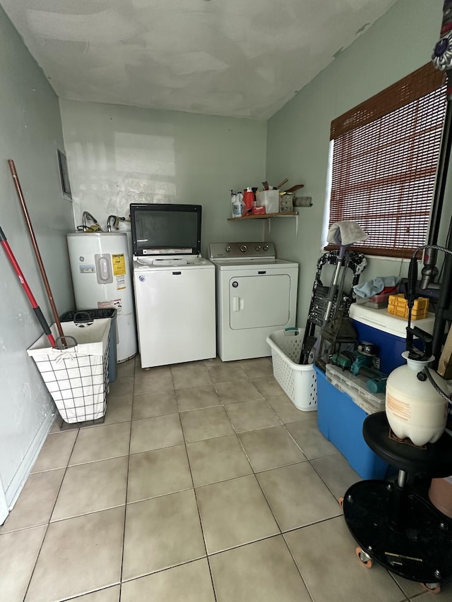 clothes washing area featuring laundry area, water heater, independent washer and dryer, and light tile patterned floors