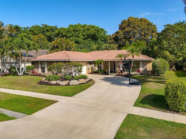 ranch-style home featuring driveway, a front lawn, an attached garage, and a tiled roof