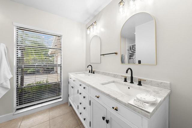 full bath featuring double vanity, a sink, and tile patterned floors