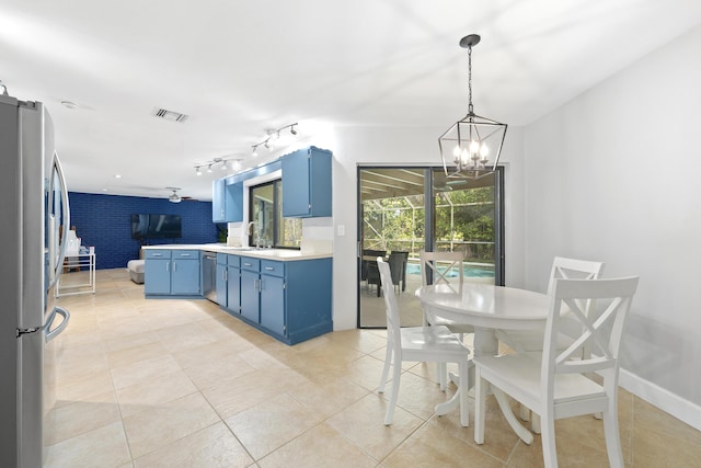 kitchen featuring blue cabinetry, light countertops, visible vents, appliances with stainless steel finishes, and a peninsula