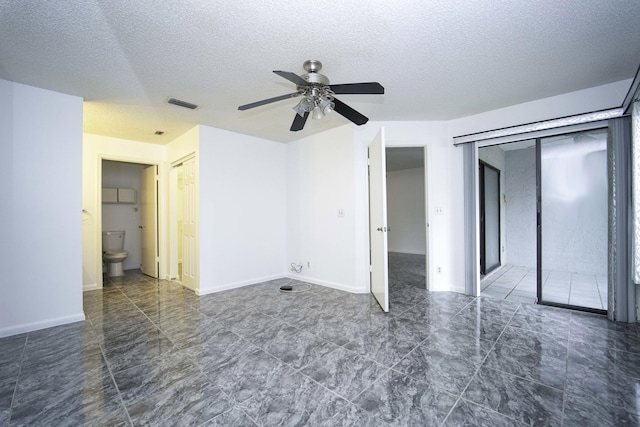 unfurnished bedroom featuring baseboards, visible vents, ceiling fan, and a textured ceiling