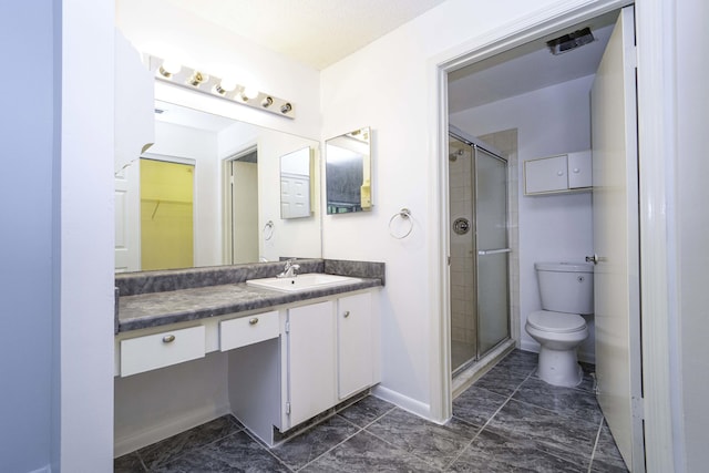 full bathroom with baseboards, a shower stall, toilet, and vanity