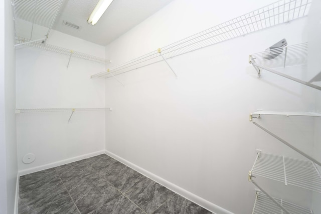 spacious closet featuring visible vents