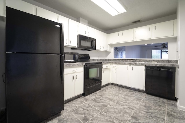 kitchen featuring black appliances, a sink, visible vents, and white cabinets