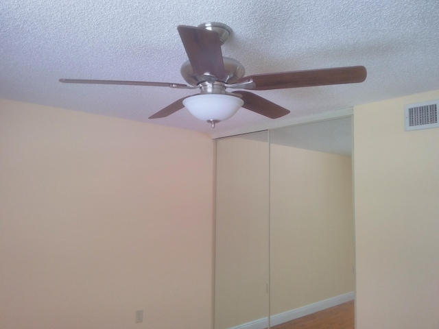 interior details featuring baseboards, visible vents, and a textured ceiling