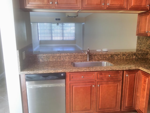 kitchen featuring a sink, visible vents, light stone counters, and dishwasher