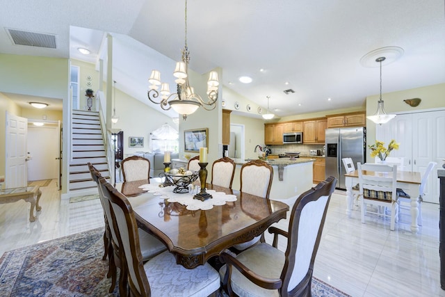 dining room featuring stairs, recessed lighting, vaulted ceiling, and a chandelier
