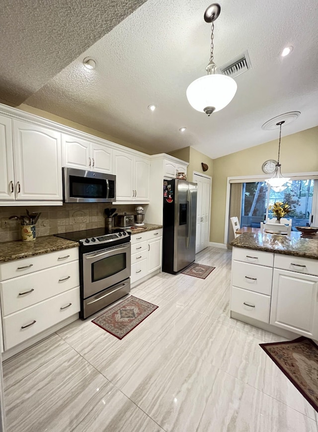 kitchen featuring stainless steel appliances, white cabinets, decorative light fixtures, a textured ceiling, and recessed lighting
