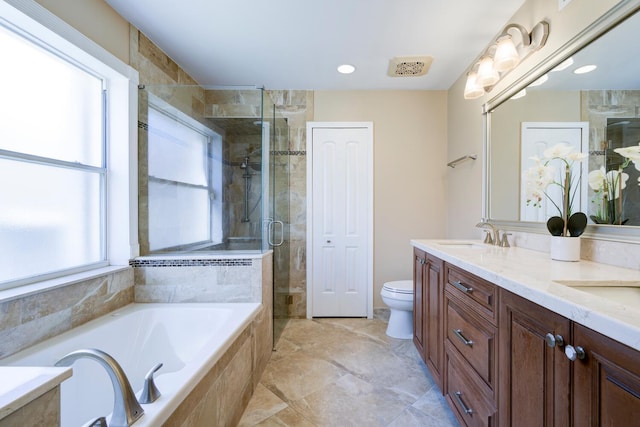 full bathroom featuring a garden tub, toilet, a sink, double vanity, and a stall shower