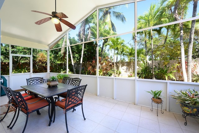 sunroom with ceiling fan, lofted ceiling, and outdoor dining space