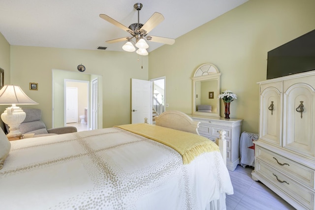 bedroom with ceiling fan, visible vents, vaulted ceiling, and ensuite bathroom