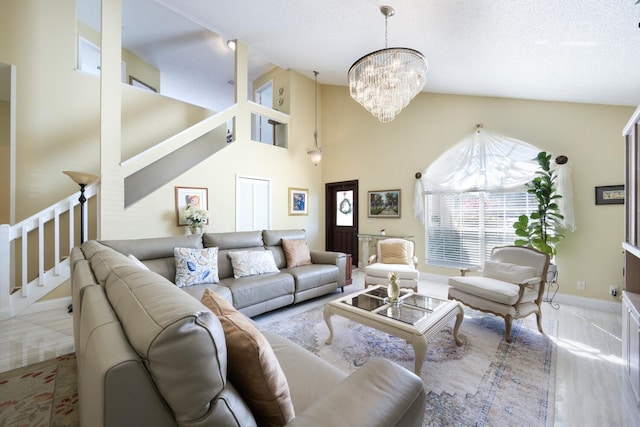 living area with a textured ceiling, high vaulted ceiling, a notable chandelier, baseboards, and stairway