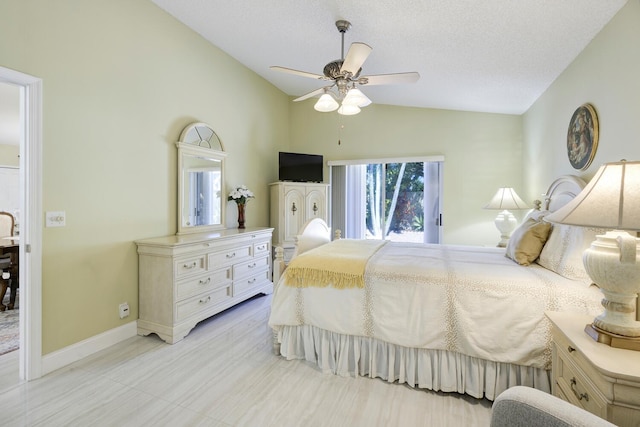 bedroom featuring lofted ceiling, ceiling fan, a textured ceiling, and baseboards