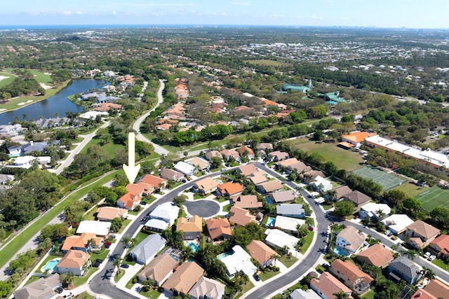 drone / aerial view featuring a residential view and a water view