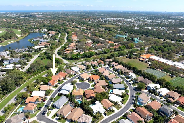 aerial view of property's location with a nearby body of water and nearby suburban area