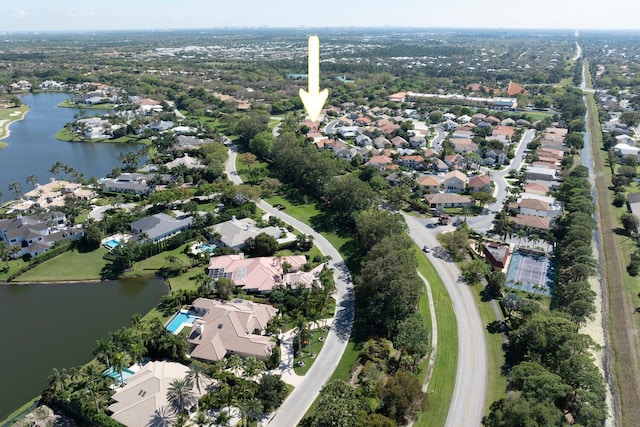 aerial view of property's location with a nearby body of water and nearby suburban area