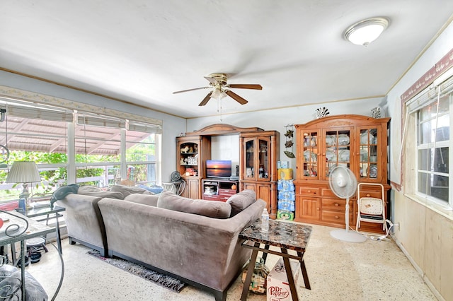 living room with a ceiling fan and speckled floor