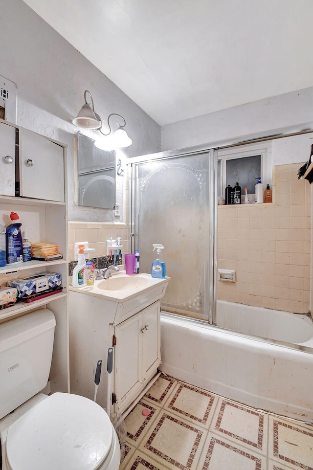 bathroom with shower / bath combination with glass door, vanity, toilet, and decorative backsplash