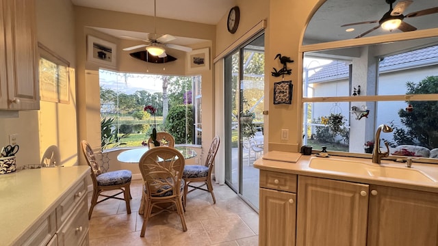 sunroom with tile patterned flooring and a sink