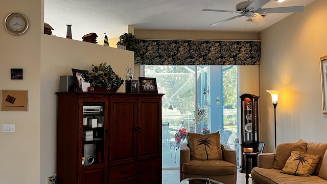 sitting room with ceiling fan and tile patterned floors