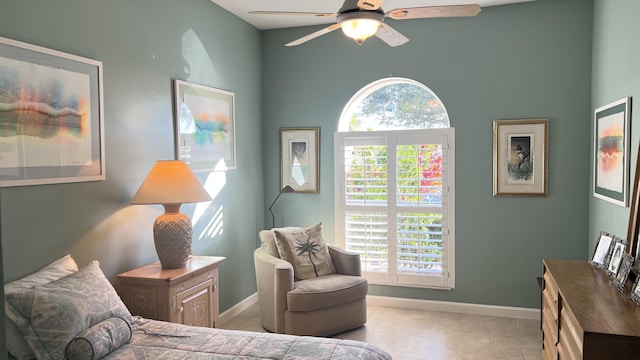 tiled bedroom with baseboards and ceiling fan