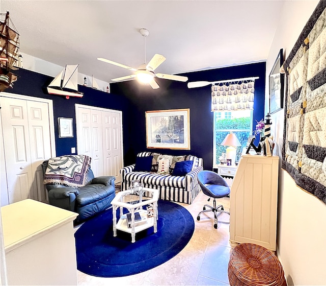 living room with tile patterned floors and ceiling fan
