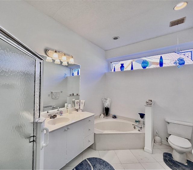 bathroom with a garden tub, a stall shower, vanity, tile patterned floors, and toilet