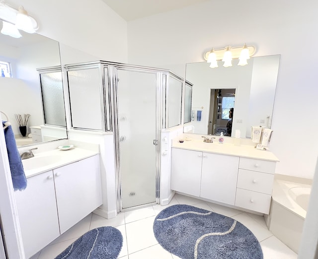 full bath with two vanities, a shower stall, a sink, and tile patterned flooring