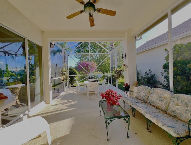 sunroom / solarium featuring ceiling fan, outdoor dining space, and an outdoor hangout area