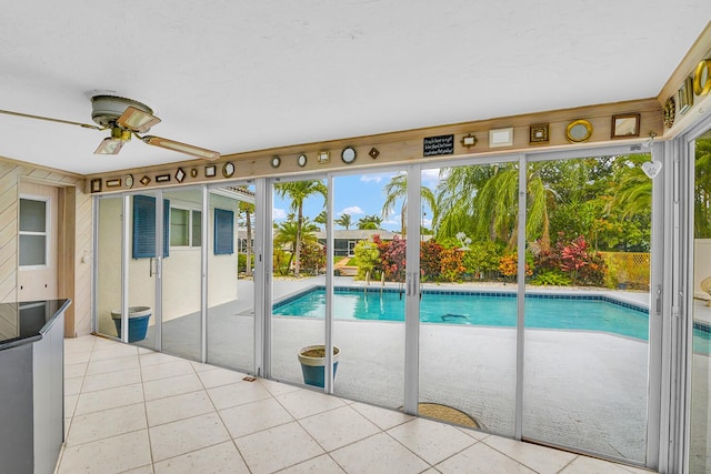 view of swimming pool with a ceiling fan, a fenced in pool, and a patio