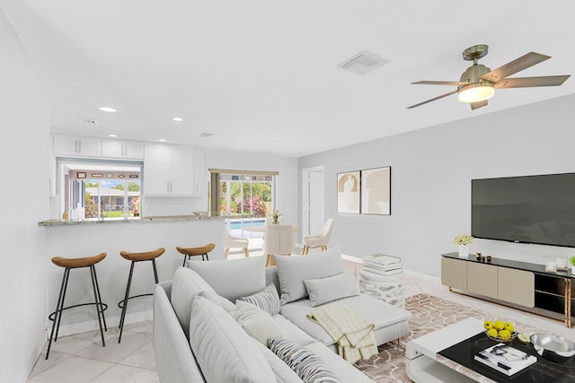 living area featuring recessed lighting, visible vents, ceiling fan, and light tile patterned flooring