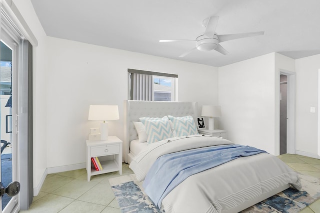 bedroom with ceiling fan, baseboards, and light tile patterned floors