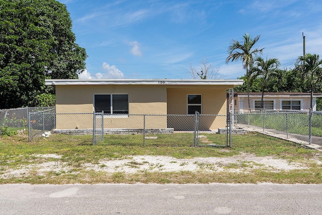 view of front of property featuring fence and stucco siding