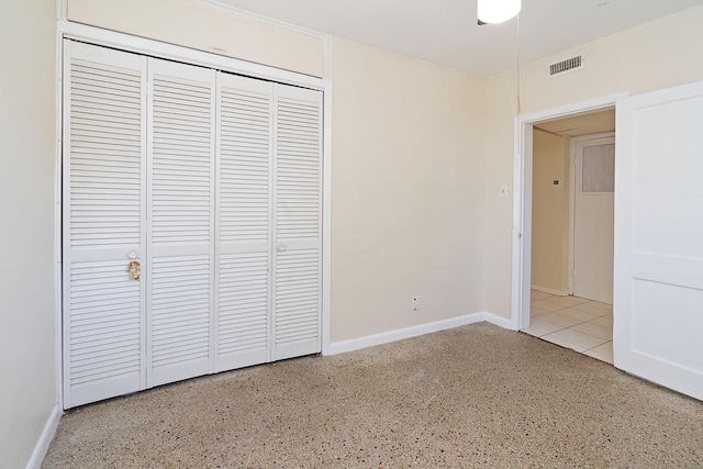 unfurnished bedroom featuring a closet, visible vents, and baseboards